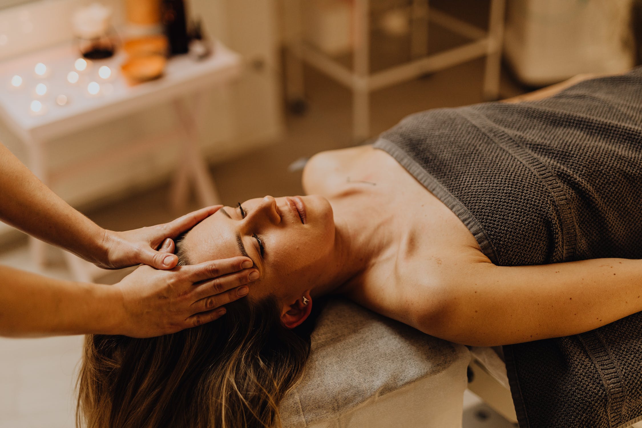 Hands of a Person Massaging a Woman's Head by Karolina Grabowska